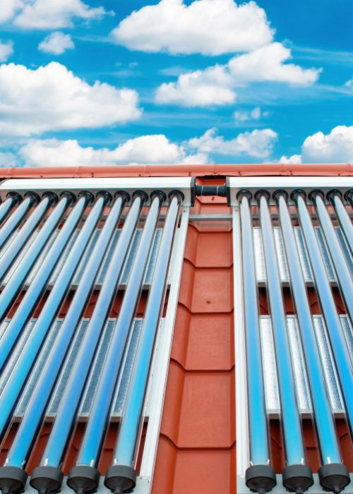 vacuum-collectors-solar-water-heating-system-on-red-roof-of-the-house_t20_g8EpYG